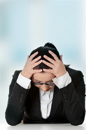 frustrated office worker with hands in hair - Sad business woman sitting behind the desk. Stock Photo - Budget Royalty-Free & Subscription, Code: 400-04837276