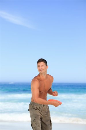 play frisbee in the beach - Man playing frisbee Stock Photo - Budget Royalty-Free & Subscription, Code: 400-04837432