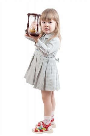 Young girl stand with hourglass Fotografie stock - Microstock e Abbonamento, Codice: 400-04837764