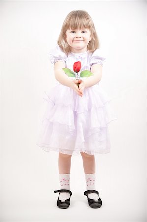 Young girl in pink dress with red rose Fotografie stock - Microstock e Abbonamento, Codice: 400-04837761