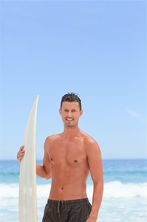 simsearch:400-05319489,k - Man posing with his surfboard Stock Photo - Budget Royalty-Free & Subscription, Code: 400-04837926