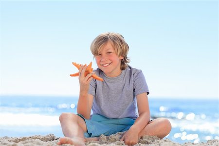 elementary boys swimming - Little boy with a starfish Stock Photo - Budget Royalty-Free & Subscription, Code: 400-04837928