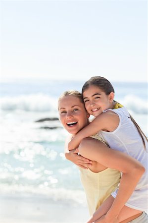 piggyback daughter at beach - Mother having daughter a piggyback at the beach Stock Photo - Budget Royalty-Free & Subscription, Code: 400-04837936