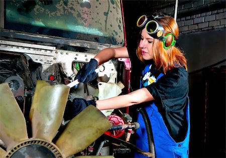 The girl repairing the engine of the lorry Stock Photo - Budget Royalty-Free & Subscription, Code: 400-04837942
