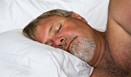 Senior man sleeping peacefully - intentional low light and shallow depth of field Stock Photo - Budget Royalty-Free & Subscription, Code: 400-04838028