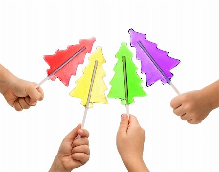 Colorful christmas tree shaped lollipops in children hands - isolated Stock Photo - Budget Royalty-Free & Subscription, Code: 400-04838077