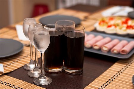 shot glasses of cold vodka and three glasses of cola and snacks on the table Stock Photo - Budget Royalty-Free & Subscription, Code: 400-04839138