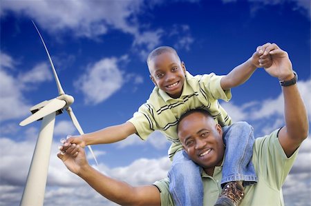 simsearch:400-04339274,k - Happy African American Father and Son with Wind Turbine Over Blue Sky. Fotografie stock - Microstock e Abbonamento, Codice: 400-04839246