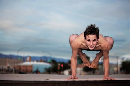 simsearch:400-04328141,k - Young Caucasian man doing the Bakasana posture Stock Photo - Budget Royalty-Free & Subscription, Code: 400-04839455