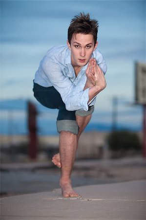 Young Caucasian man crouches on one leg for yoga exercises outdoors Stock Photo - Budget Royalty-Free & Subscription, Code: 400-04839458