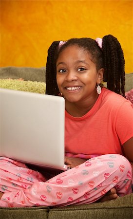 Happy little African American girl using a laptop Stock Photo - Budget Royalty-Free & Subscription, Code: 400-04839461