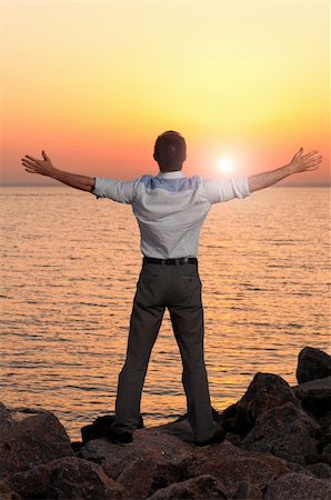 relax businessman silhouette - businessman is standing near the sea at sunrise Stock Photo - Budget Royalty-Free & Subscription, Code: 400-04839783