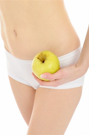 woman with beautiful body holding an apple near the slim waist. isolated on white background Stock Photo - Budget Royalty-Free & Subscription, Code: 400-04830053