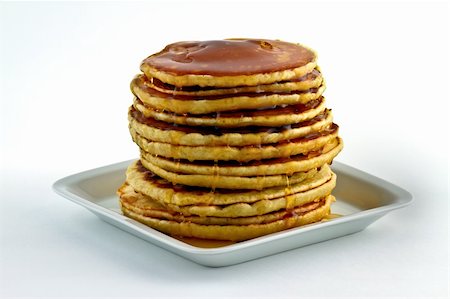 simsearch:400-07510513,k - Pancakes with syrup poured over at dish on white background Stock Photo - Budget Royalty-Free & Subscription, Code: 400-04830096