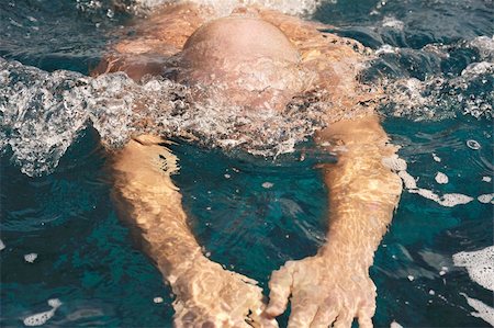 Detail of young man swimming Stock Photo - Budget Royalty-Free & Subscription, Code: 400-04830410