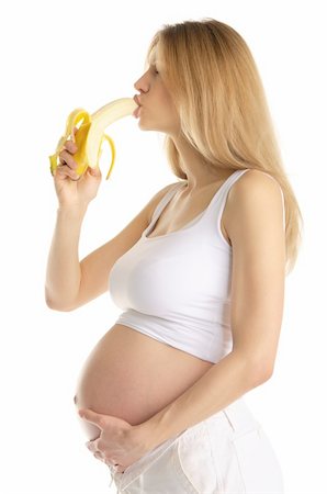 pretty women eating banana - pregnant woman is sexually bites banana isolated on white Photographie de stock - Aubaine LD & Abonnement, Code: 400-04830540