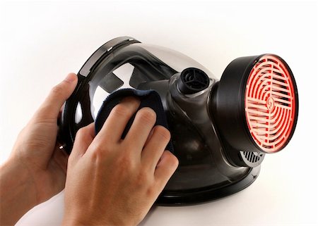 simsearch:400-08077627,k - Hands cleaning a black gas mask with a piece of blue cloth Stock Photo - Budget Royalty-Free & Subscription, Code: 400-04830542