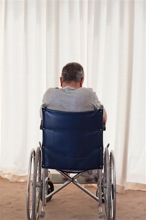 simsearch:400-04327098,k - Mature man in his wheelchair with his back to the camera at home Stock Photo - Budget Royalty-Free & Subscription, Code: 400-04830639