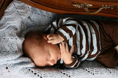 One month old baby boy sleeping in a drawer Stock Photo - Budget Royalty-Free & Subscription, Code: 400-04831135