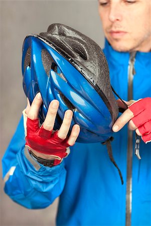 Close-up of a cyclist putting on his helmet. Stock Photo - Budget Royalty-Free & Subscription, Code: 400-04831156