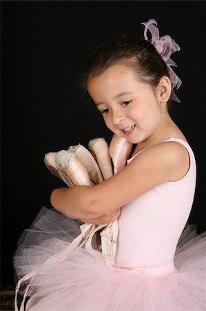 simsearch:400-07302639,k - Cute brunette ballet girl holding lots of pointe shoes Stock Photo - Budget Royalty-Free & Subscription, Code: 400-04831169