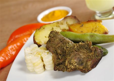 peruvian cooking - Pachamanca, which is a traditional meal from the Peruvian highlands, is made of different kinds of meat with beans and corn as well as potatoes and sweet potatoes, and is traditionally cooked in the ground (Selective Focus, Focus on the upper right part of the meat) Photographie de stock - Aubaine LD & Abonnement, Code: 400-04831162