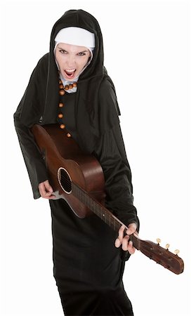 simsearch:400-05315102,k - Funny nun sings a song while playing her guitar Photographie de stock - Aubaine LD & Abonnement, Code: 400-04831185