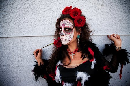 dia de los muertos - Woman in face paint with rose and finger on wall Photographie de stock - Aubaine LD & Abonnement, Code: 400-04831228