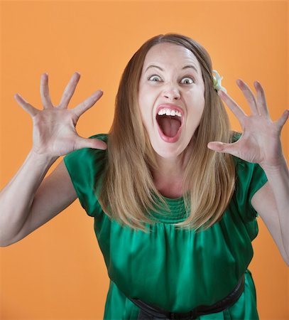 Scary attractive Caucasian woman on orange background Stock Photo - Budget Royalty-Free & Subscription, Code: 400-04831251