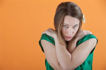 Beautiful Caucasian Woman isolated on an orange background with arms crossed Stock Photo - Budget Royalty-Free & Subscription, Code: 400-04831252