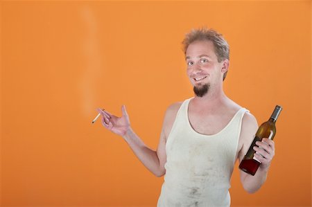 Happy Caucasian man holding a bottle and a cigarette Stock Photo - Budget Royalty-Free & Subscription, Code: 400-04831307