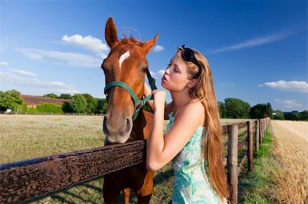 horse and blond girl in paddock on summers day Stockbilder - Microstock & Abonnement, Bildnummer: 400-04831357