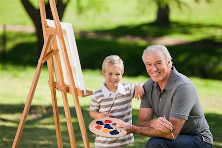 Grandfather and his grandson painting in the garden Stock Photo - Budget Royalty-Free & Subscription, Code: 400-04831387