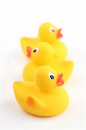 Three yellow rubber ducklings on white background. Shallow dof Stock Photo - Budget Royalty-Free & Subscription, Code: 400-04831523