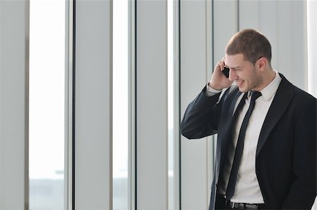 simsearch:400-04180586,k - young business man talk by cellphone over bright window in big hall Stockbilder - Microstock & Abonnement, Bildnummer: 400-04831606