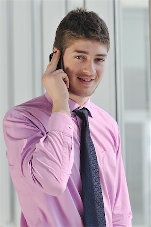 simsearch:400-08750050,k - young business man talk by cellphone over bright window in big hall Stock Photo - Budget Royalty-Free & Subscription, Code: 400-04831622