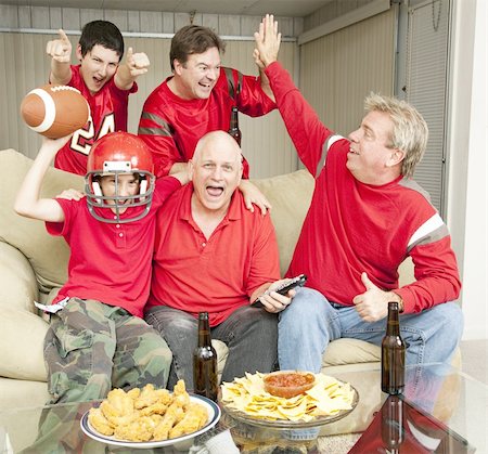 family in sports jerseys - Football fans excited because their team is winning. Stock Photo - Budget Royalty-Free & Subscription, Code: 400-04831818