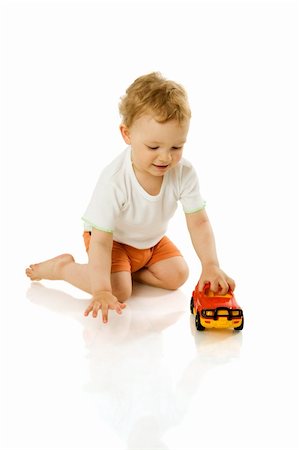 Happy Boy holding toy car laughing isolated on white Stockbilder - Microstock & Abonnement, Bildnummer: 400-04832579