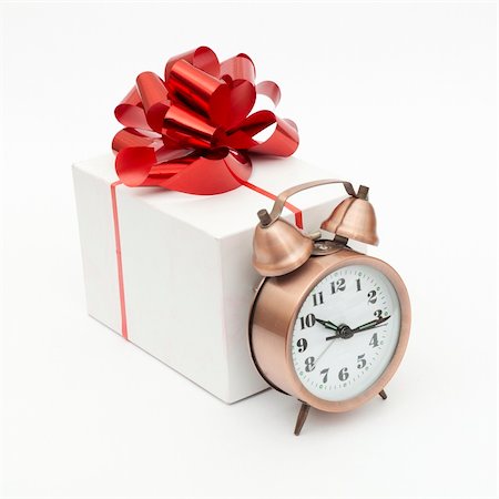 A retro clock with presents isolated on white bacground Fotografie stock - Microstock e Abbonamento, Codice: 400-04832843