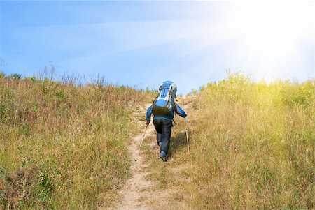 simsearch:400-04044871,k - Hiker with rucksack up-hill at summer sunny day Photographie de stock - Aubaine LD & Abonnement, Code: 400-04833816