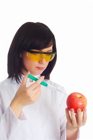Woman scientist injecting chemicals into apple on white Foto de stock - Super Valor sin royalties y Suscripción, Código: 400-04844731