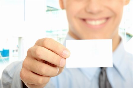 simsearch:400-05718318,k - Young happy smiling successful business man with blank business card or sign Foto de stock - Super Valor sin royalties y Suscripción, Código: 400-04844763