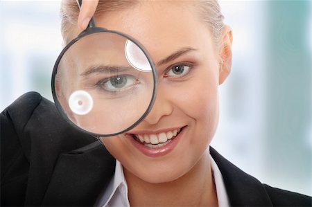 simsearch:400-05142003,k - Young attractive smiling business woman looking into a magnifying glass, isolated on white background Photographie de stock - Aubaine LD & Abonnement, Code: 400-04844902