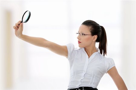 simsearch:400-04554899,k - Young attractive business woman looking into a magnifying glass Stock Photo - Budget Royalty-Free & Subscription, Code: 400-04845218