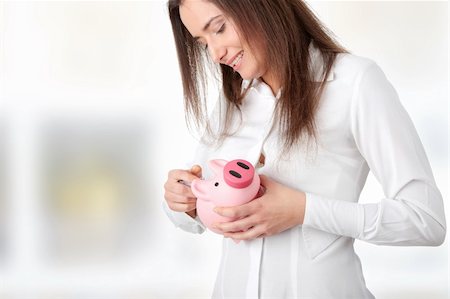 Young beautiful woman standing with piggy bank (money box) Stock Photo - Budget Royalty-Free & Subscription, Code: 400-04845240