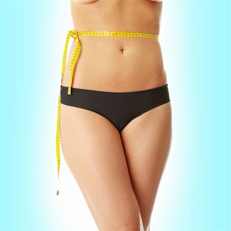 Slim woman with measuring tape on belly Stock Photo - Budget Royalty-Free & Subscription, Code: 400-04845260