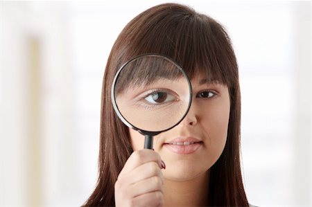 simsearch:400-04554899,k - Young attractive smiling business woman looking into a magnifying glass Stock Photo - Budget Royalty-Free & Subscription, Code: 400-04845308