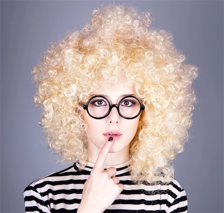 Portrait of funny girl in blonde wig. Studio shot. Stockbilder - Microstock & Abonnement, Bildnummer: 400-04845562