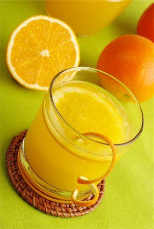 drink coaster - Fresh orange juice with orange slice in glass and oranges in background on green table mat (Selective Focus) Stock Photo - Budget Royalty-Free & Subscription, Code: 400-04846762