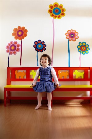 hispanic female preschooler sitting on bench in kindergarten and smiling. Vertical shape, full length, front view Stock Photo - Budget Royalty-Free & Subscription, Code: 400-04846848